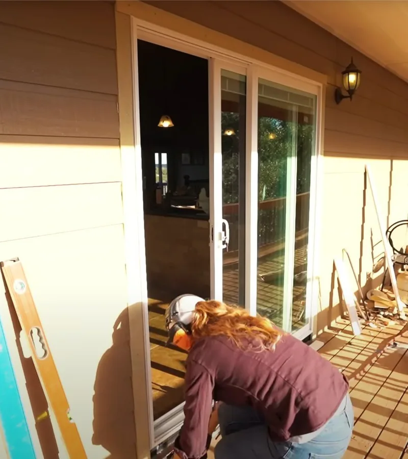 Dean technician working beside a sliding patio door